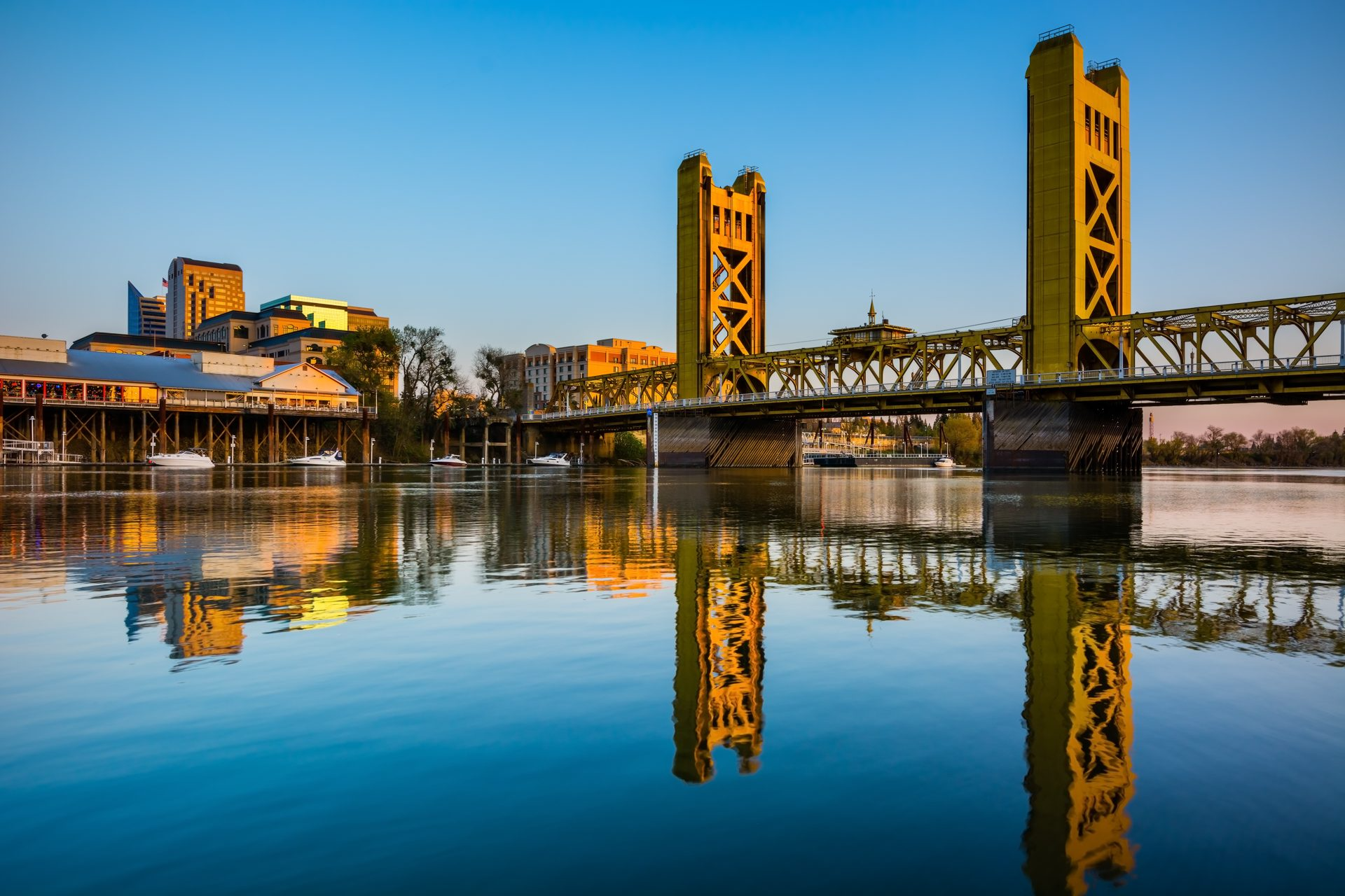 Sacramento Tower Bridge at golden hour with downtown skyline reflection